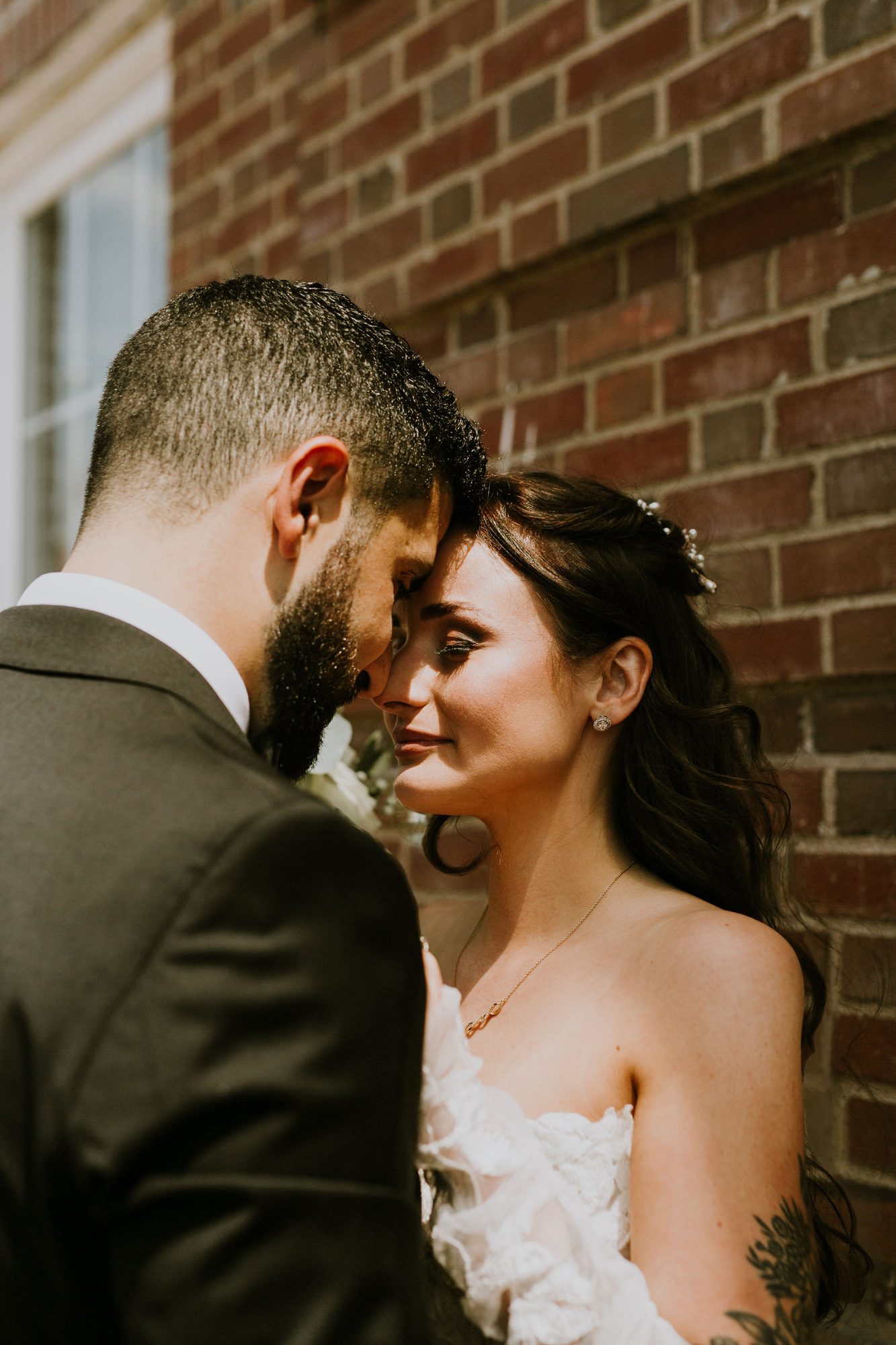 Kara and Leo, forehead to forehead, during their first look outside the Westin hotel in Halifax