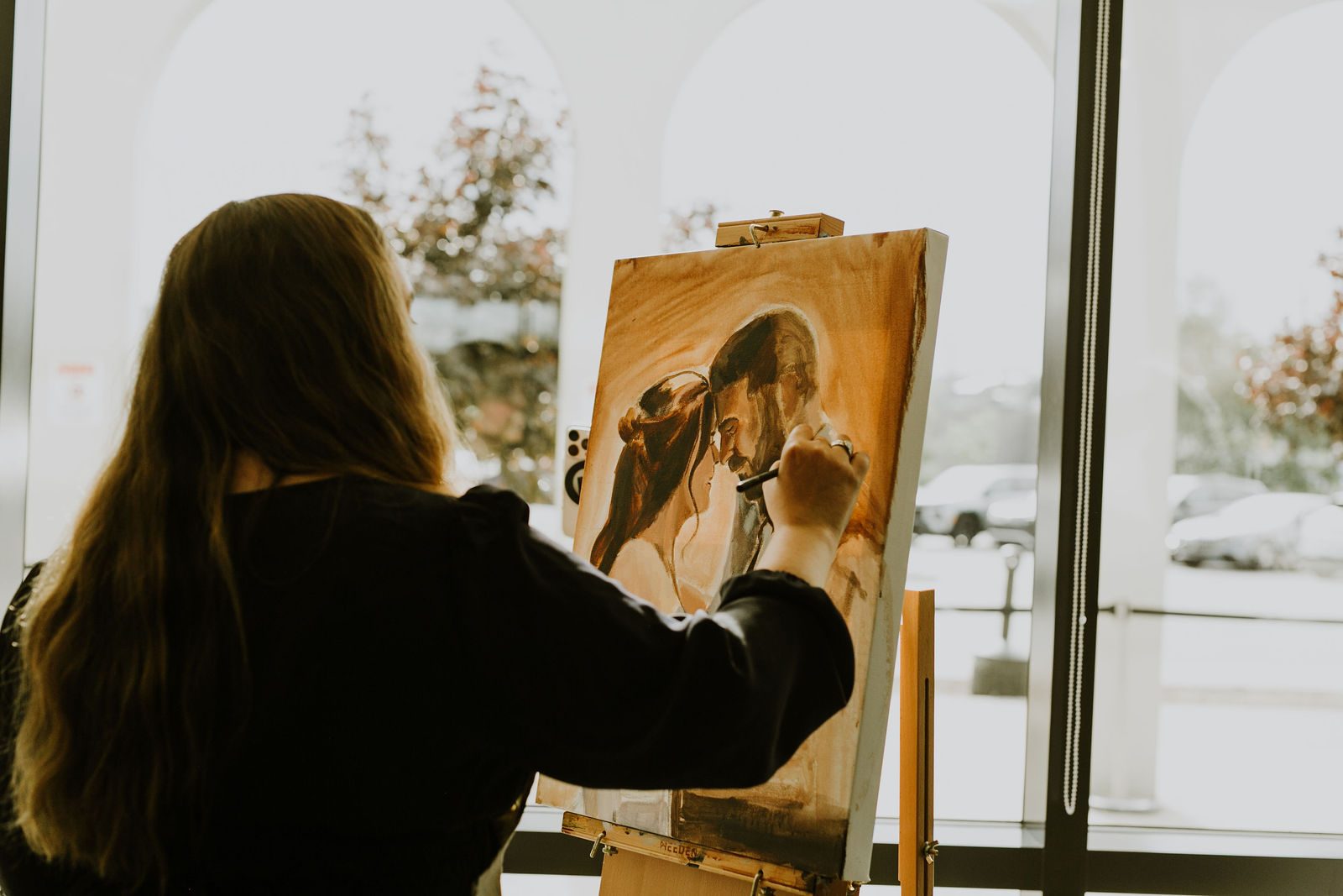 Heather LeBlanc painting live at her easel during the wedding reception at Cedar Event Centre
