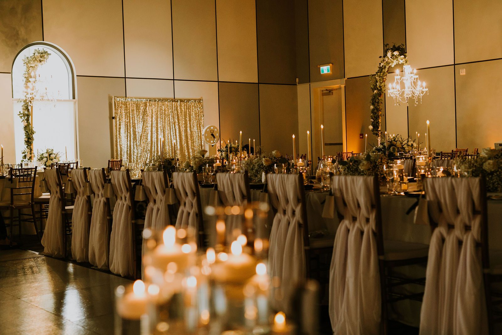 The reception room at Cedar Event Centre set with candlelight before guests arrive