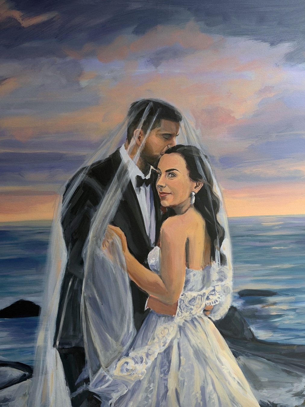 Only Want To Be With You — a bride and groom sharing a veiled embrace on a rocky shoreline at sunset